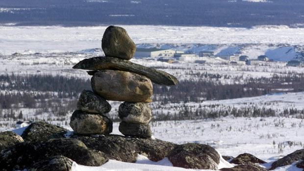 An Inukshuk stands on top of a hill overlooking the town of Kuujjuaq, Que. Photo: Jacques Boissinot, The Canadian Press.