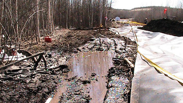 Workers clean up oil that leaked from Enbridge's Norman Wells pipeline near Wrigley, N.W.T., on May 9. The company estimates that 700 to 1,500 barrels of oil had leaked from the pipeline. Photo submitted by D'Arcy J. Moses.