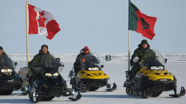 Defence Minister Peter McKay and then Chief of Defence Staff Gen. Walter Natynczyk lead a parade of Canadian Rangers and regular-force soldiers up the runway of CFS Alert at the close of Operation Nunalivut in 2010. (Canadian Press)