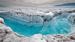 Surface melt water rushes along the surface of the Greenland ice sheet. (Image courtesy Ian Joughin) CBC.ca