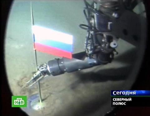  A Russian NTV channel grab taken 03 August 2007 shows a manipulator of the Mir-1 mini-submarine as it places a Russian state flag at the seabed of Arctic ocean at a depth of 4,261 meters (13,980 feet), 02 August 2007. Russian newspapers lauded members of an Arctic expedition who planted a Russian flag in the seabed four kilometres (2.5 miles) beneath the North Pole. AFP PHOTO / NTV 