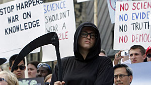 Canadian scientists, including a protestor wearing a Grim Reaper costume, take part in a rally on Parliament Hill on July 10, 2012, protesting against federal cuts to science research. (Fred Chartrand / Canadian Press)