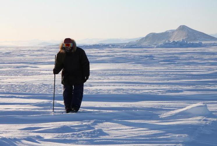 Inuit hunter Elijah Palituk looks for seal breathing holes in the ice off the coast of northeast Baffin Island in Canada's eastern Arctic territory of Nunavut. Photo: Levon Sevunts, Radio Canada International.