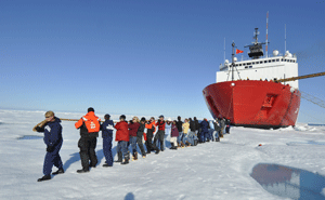 ICESCAPE researchers pretend to pull the huge U.S. Coast Guard vessel that ferried them out into the Arctic. Ocean The algae analysis was just one tiny part of the extensive research the scientists did on their 2011 trip. (Gert van Dijken)