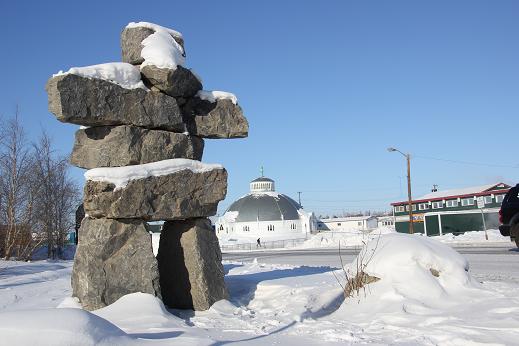 Inukshuk in central Inuvik with Igloo Church in back ground. Photo: Eilis Quinn, Radio Canada International.
