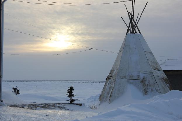 View of Great Bear Lake from Deline, Northwest Terriotires. Most homes have traditional Dene teepees in their yards used for smoking meats and tanning hides. Photo: Eilís Quinn.