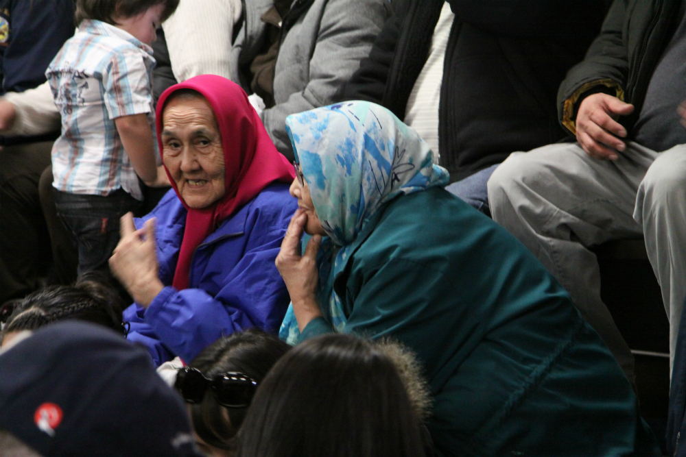 Two elderly Dene women discuss the game. Photo by Levon Sevunts