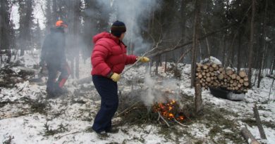 France and Doug are burning branches and brush to protect their log house from summer forest fires.