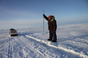 Elijah Pallituq demonstrates how Inuit hunters use harpoons to hunt seals under sea ice. Photo by Levon Sevunts.