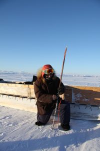 Inuit hunter and guide Elijah Pallituq demonstrates a harpoon used for seal hunting in emergency situations. Photo by Levon Sevunts.