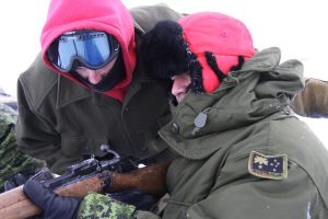 An Australian officer on an exchange program with Canadian Forces receives instructions on using the Lee Enfield rifle. Photo by Levon Sevunts.