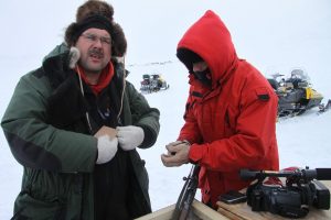 Canadian Rangers break new ammunition boxes to reload their weapons. Photo by Levon Sevunts.