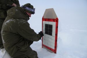 A Canadian soldier marks his shots on the paper target. Photo by Levon Sevunts.