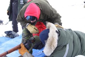 The range officer examines the breach of the rifle. Photo by Levon Sevunts.