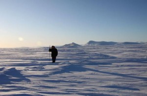 Inuit hunter and guide Elijah Pallituq walks on sea ice checking for seal breathing holes along the cracks in sea ice. (Levon Sevunts, Radio Canada International)