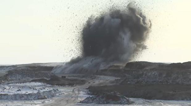 An explosion near Tuktoyaktuk releases gravel at the beginning highway construction season in 2014. (CBC)