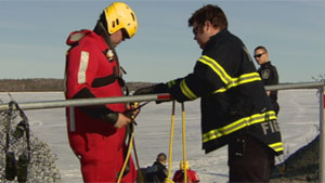 Yellowknife fire crews donned ice rescue gear to help a man and his dogs who fell through ice on Yellowknife Bay Friday. (CBC)