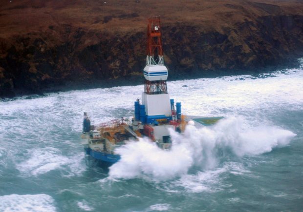 Waves crash over the mobile offshore drilling unit Kulluk where it sits aground on the southeast side of Sitkalidak Island, Alaska, Jan. 1, 2013. (US Coast Guard photo)
