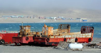 The hamlet of Resolute is seen beyond two barges on the shore of Resolute Bay in 2011. (Sean Kilpatrick/Canadian Press)