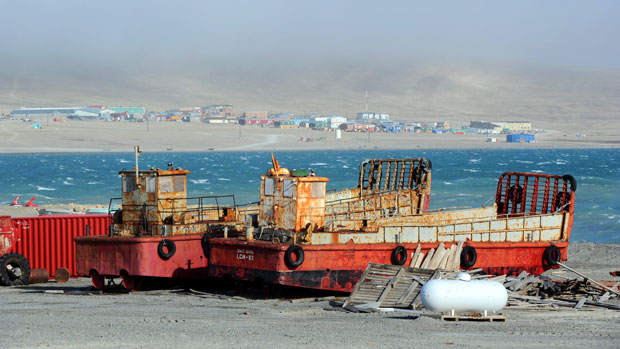 The hamlet of Resolute is seen beyond two barges on the shore of Resolute Bay in 2011. (Sean Kilpatrick/Canadian Press)