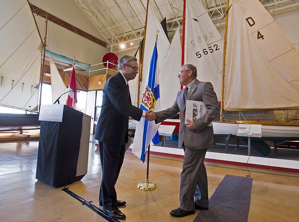 Premier Darrell Dexter, right, and Natural Resources Minister Joe Oliver shake hands at a news conference at the Maritime Museum of the Atlantic in Halifax on Tuesday, June 18, 2013. Oliver announced that Ottawa is raising the liability cap for companies operating in Atlantic Canada's offshore to one billion dollars under new proposed legislation. (Andrew Vaughan / The Canadian Press)