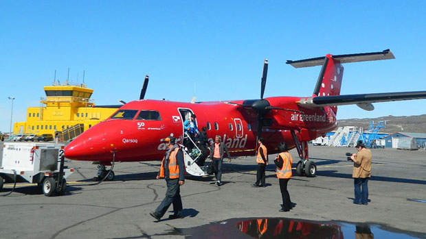 Passengers exit an Air Greenland Dash 8 after arrival at the Iqaluit airport from Nuuk last summer. This year's first flight of the year was cancelled, possibly due to lack of demand. (Daniel MacIsaac/CBC)