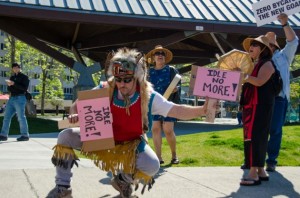 John Smith the 3rd dances with protest signs at the Idle No More rally at Marine Park. (Heather Bryant / KTOO)