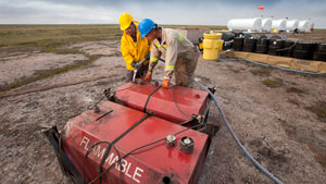 Two men work at the fuel storage site at the proposed Kiggavik uranium mine, near Baker Lake. (The Canadian Press)