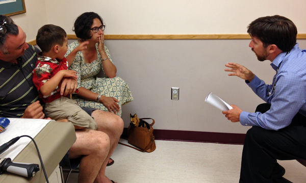 Pediatric Resident Dr. Eric Foote meets with a family at LaTouche Pediatrics in Anchorage. (Annie Feidt / APRN – Anchorage)