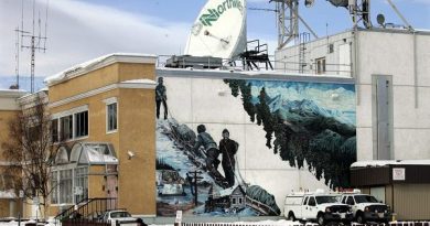 A man walks past Norwestel office in Whitehorse, Yukon. (Chuck Stoody / The Canadian Press)