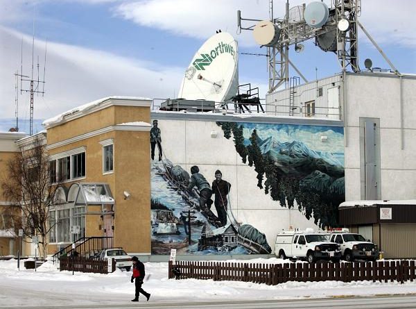 A man walks past Norwestel office in Whitehorse, Yukon. (Chuck Stoody / The Canadian Press)