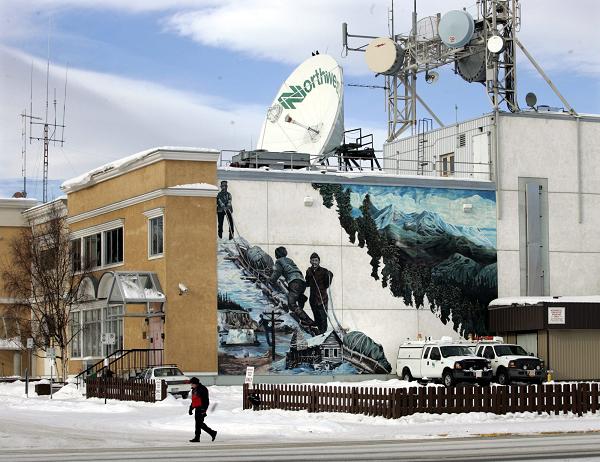 A man walks past Norwestel office in Whitehorse, Yukon. (Chuck Stoody / The Canadian Press)
