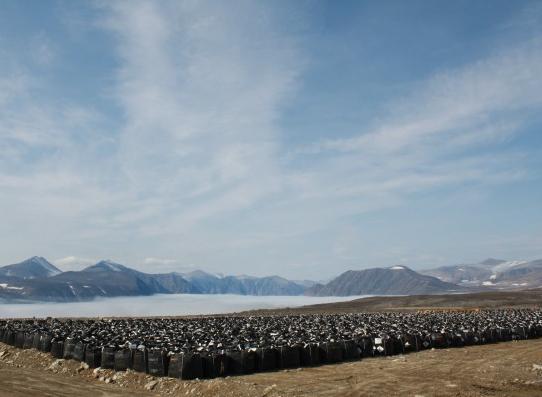 Bags of contaminated soil are lined up, waiting to be shipped south for disposal. (Paul Tukker / CBC)