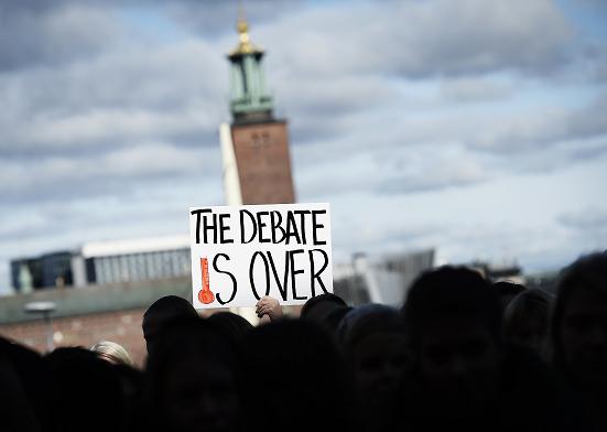 People scream outside the United Nation’s Intergovernmental Panel on Climate Change (IPCC) to demand immediate political action on Climate debate on September 27, 2013 in Stockholm. The panel said it was more certain than ever that humans were the cause of global warming and predicted temperatures would rise another 0.3 to 4.8 degrees Celsius this century. (Jonathan Nackstrand / AFP)