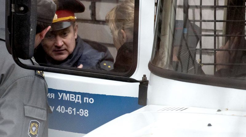 A handout picture taken on October 2, 2013 and released by Greenpeace International shows Greenpeace activist Sini Saarela from Finland being escorted in a court in the northern Russian city of Murmansk. (Dmitri Sharomov / Greenpeace / AFP)