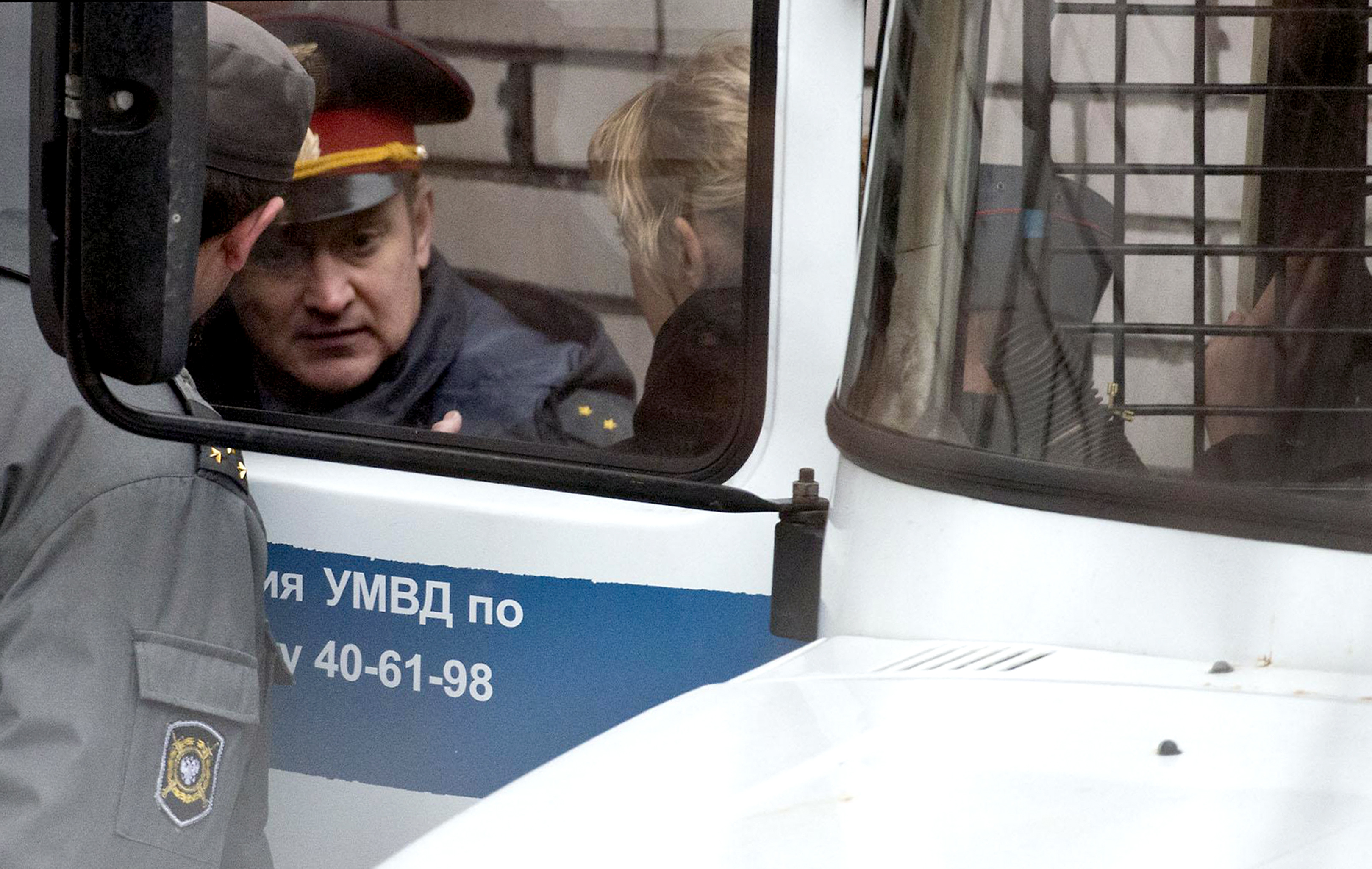 A handout picture taken on October 2, 2013 and released by Greenpeace International shows Greenpeace activist Sini Saarela from Finland being escorted in a court in the northern Russian city of Murmansk. (Dmitri Sharomov / Greenpeace / AFP)