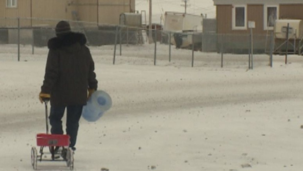Simon Okpakok makes this walk twice daily to get water for his family's home. (CBC)