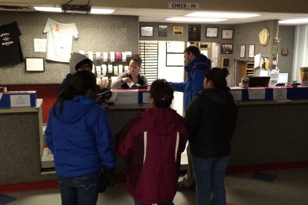 Residents of Napaskiak, a Yu'pik village on the Kuskokwim River, wait at Grant Aviation for a Cessna 207 to fly them home from Bethel, a regional hub in western Alaska where they work and go to school. Nov. 22, 2013 (Jill Burke / Alaska Dispatch)