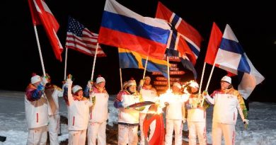 Arctic explorer Artur Chilingarov (C) lighting the Olympic flame at the North Pole. (Sochi 2014 Organizing Committee / AFP)