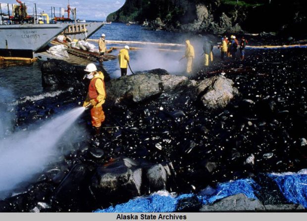 Spill workers hose a beach down after a Corexit oil dispersant test in the wake of the Exxon Valdez spill. (Courtesy Alaska State Archives / Alaska Dispatch)