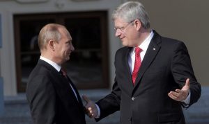 Russia's President Vladimir Putin, left, speaks with Canada's Prime Minister Stephen Harper during arrivals for the G-20 summit at the Konstantin Palace in St. Petersburg, Russia on Sept. 5, 2013. (Dmitry Lovetsky/ AP)