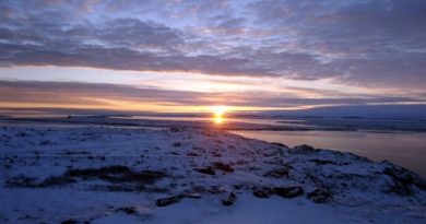 Sunrise in Kugluktuk, Nunavut. The hamlet's emergency siren now sounds at 8:30 a.m. every school day to get the kids out of bed and into class. (Peter Kakolak)