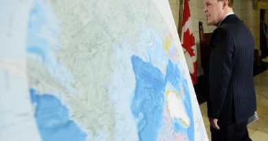 Foreign Affairs Minister John Baird walks past a map of the Arctic at a news conference on Canada’s Arctic claim in Ottawa, on Dec 9 2013. (Sean Kilpatrick / The Canadian Press)