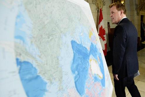 Foreign Affairs Minister John Baird walks past a map of the Arctic at a news conference on Canada’s Arctic claim in Ottawa, on Dec 9 2013. (Sean Kilpatrick / The Canadian Press)