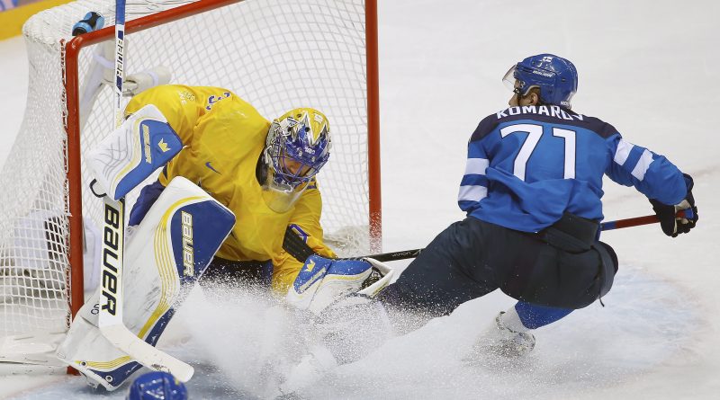 Finland forward Leo Komarov skates into Sweden goaltender Henrik Lundqvist during the third period of the men's semifinal ice hockey game at the 2014 Winter Olympics, Friday, Feb. 21, 2014, in Sochi, Russia. (Matt Slocum/AP)