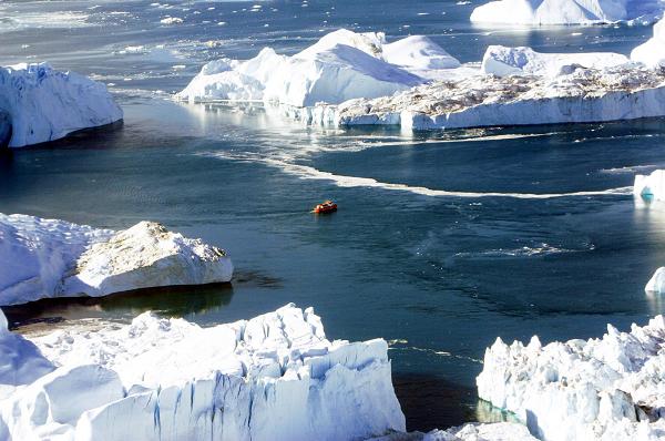 A boat makes its way through the icebergs in Disko Bay, Greenland. (John McConnico/AP)