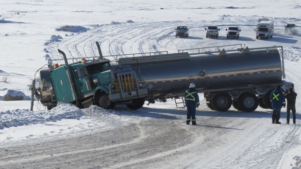 One of the two trucks carrying a mix of water, chemicals and sand used at ConocoPhillips' N.W.T. fracking project that slid off the Sahtu winter road over the past week. (courtesy of Roger Odgaard/Facebook/CBC.ca)