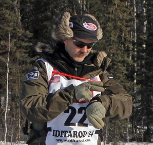 Robert Sorlie checks the time as he departs from Willow. Photo by Josh Edge, APRN – Anchorage.