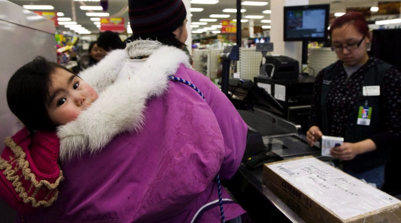 Food security is an issue in communities across the North. Here, Pauline Kadjuk, 1, is carried in a Amautik by her mother Brittany Ikulik, middle, while paying for groceries at the Northern store in the small town of Baker Lake, Nunavut. (Nathan Denette / The Canadian Press)