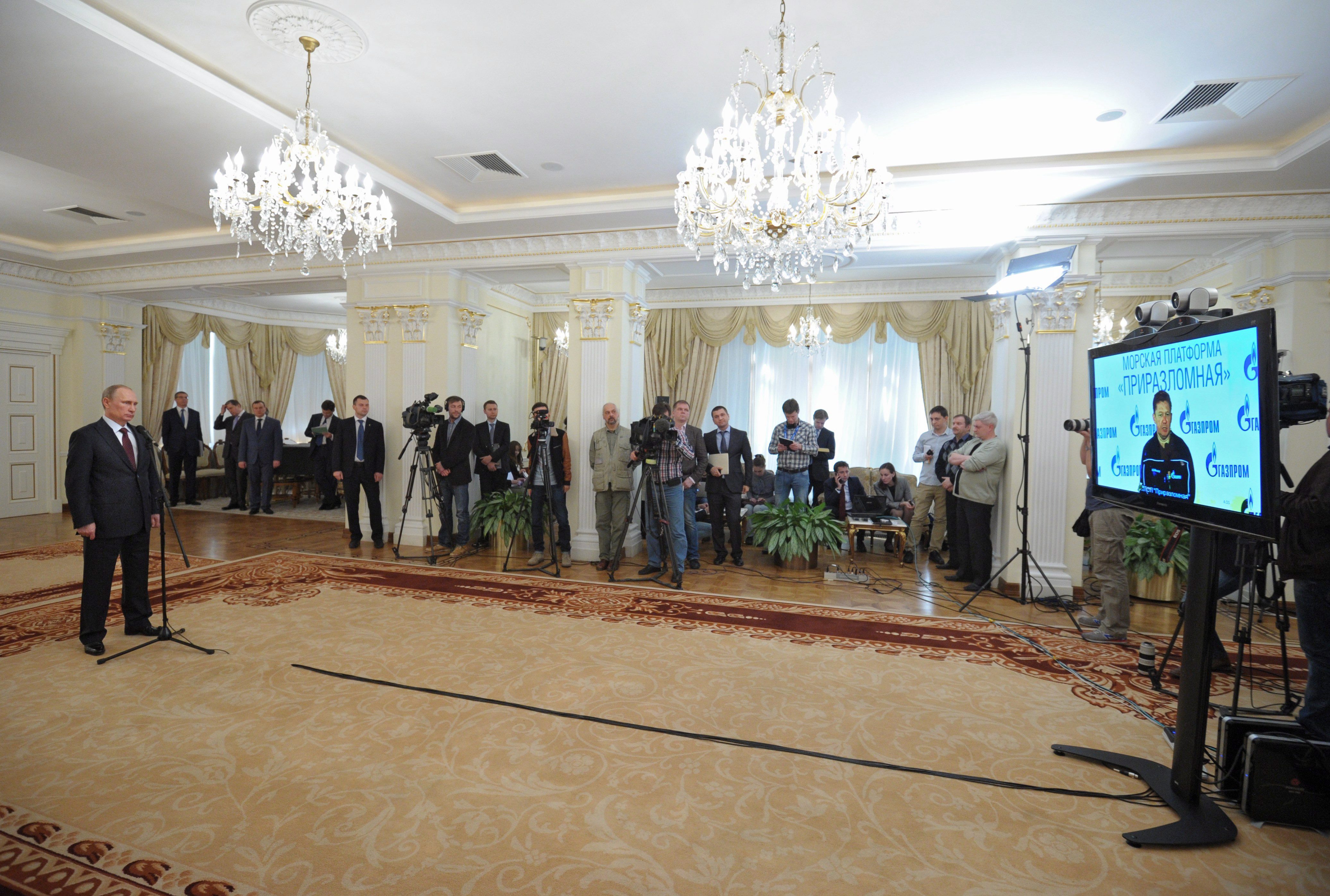 Russian President Vladimir Putin, left, speaks with Gazprom Head Alexei Miller as he attends a video call with the Prirazlomnaya arctic oil platform marking the launch of production in the Novo-Ogaryovo residence outside Moscow, Russia, Friday, April 18, 2014. (Alexei Druzhinin / RIA-Novosti / Presidential Press Service / AP )